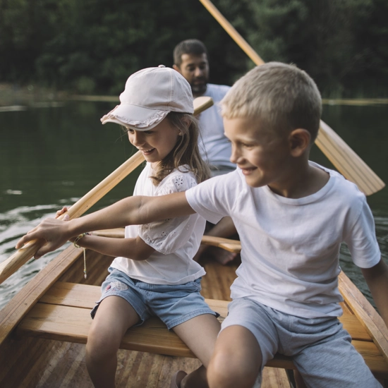 Enfants heureux sur un canot avec leur père